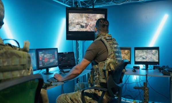 Military,Men,Working,On,Computer,Systems,While,Hiding,In,Secret